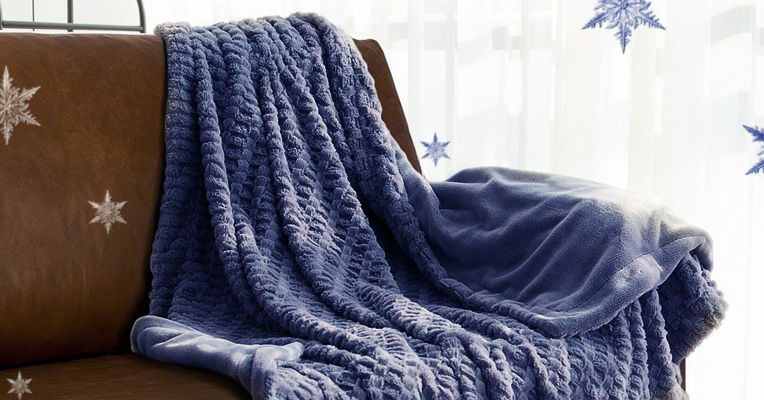 A blanket styled on one of the corners of the couch